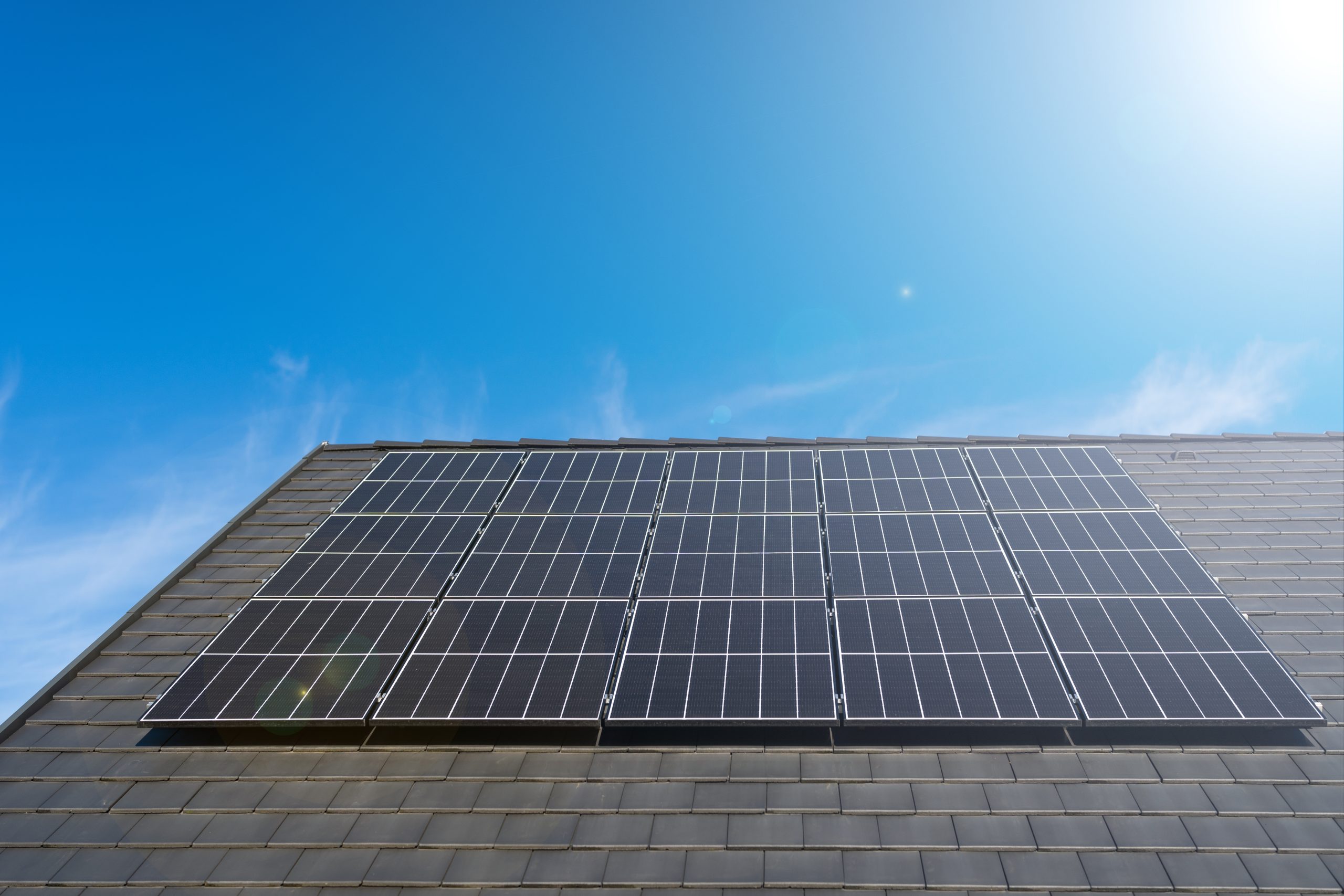 Photovoltaic,Panels,On,A,New,Roof,Against,A,Clear,Blue Photovoltaic,Panels,On,A,New,Roof,Against,A,Clear,Blue